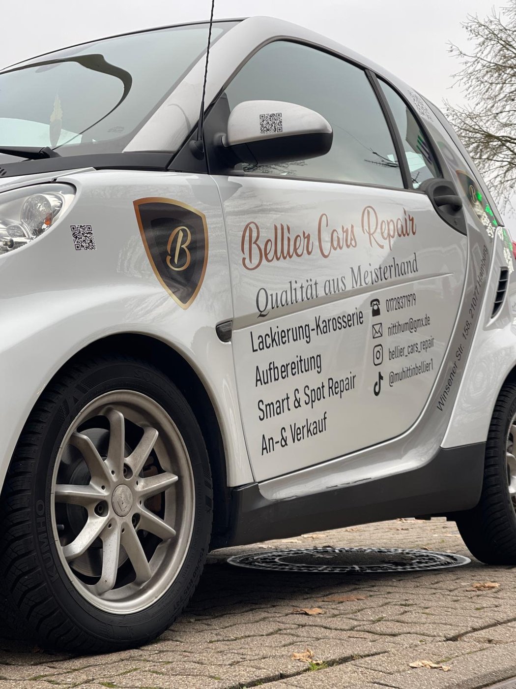 Weißer Firmenwagen von Bellier Cars & Repair, Seiten- und Felgenansicht